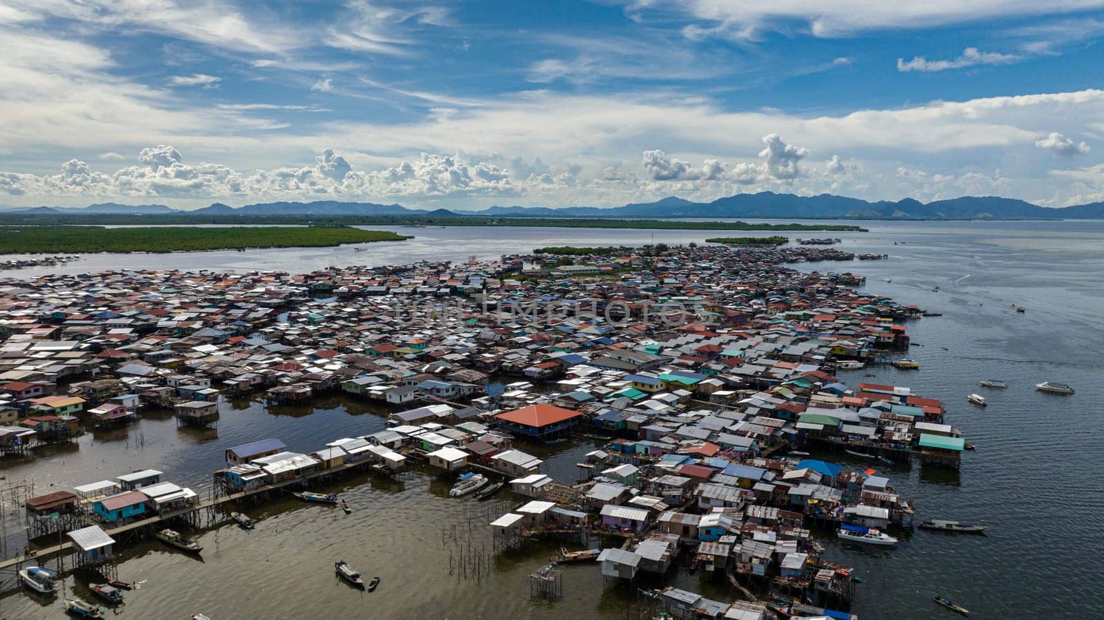 Aerial view of fishing village located on the water in the sea. Houses of the poor. Borneo,Semporna. Sabah, Malaysia.