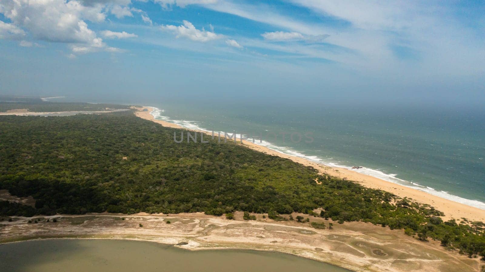 Wild beach in the national park surrounded by rainforest and jungle.