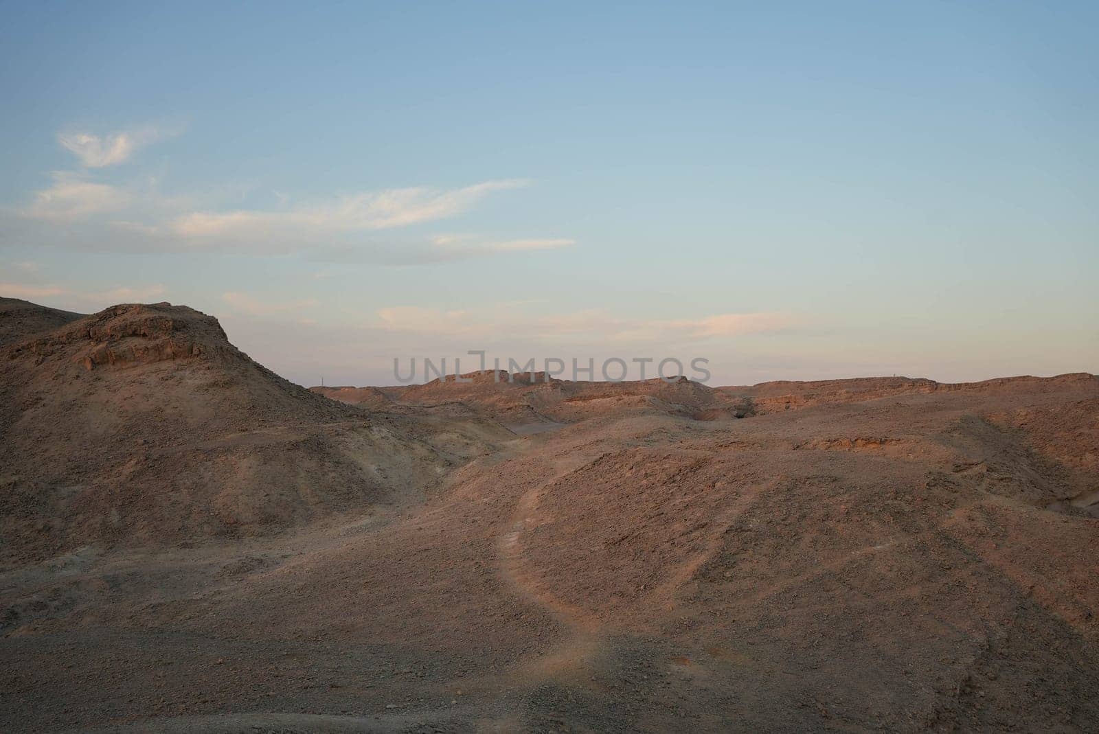 Desert landscape with hills and skyline in the evening at sunset. High quality photo