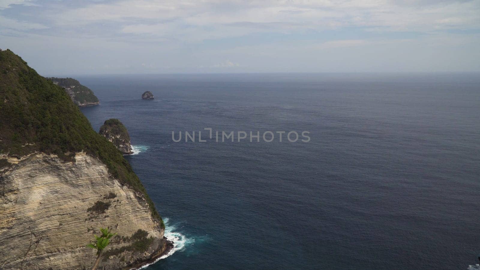 Seascape, rocky coast, ocean, blue sea, waves, Nusa Penida, Indonesia. Ocean with waves and rocky cliff Travel concept