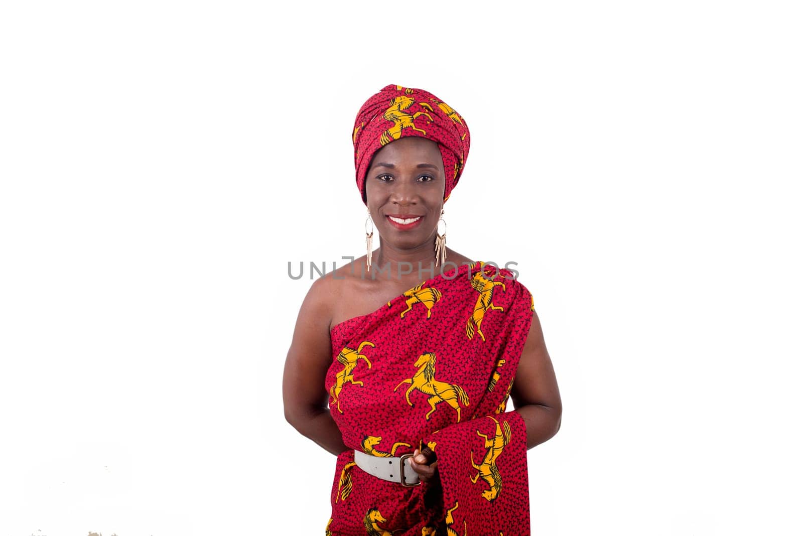 young woman standing in loincloth in a studio watching the camera smiling.