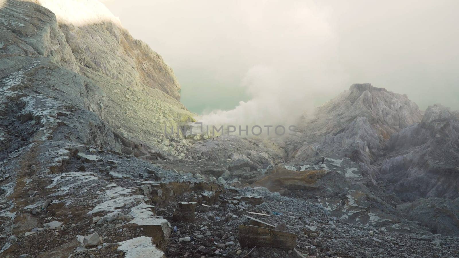 Extraction of sulfur in the crater of a volcano. Sulfur gas, smoke. Kawah Ijen, crater with acidic crater lake where sulfur is mined. Ijen volcano complex is a group of stratovolcanoes in the Banyuwangi Regency of East Java, Indonesia.