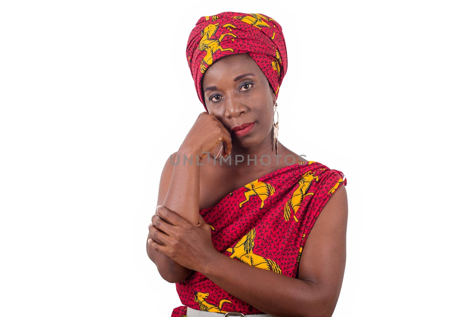 fashionable woman in traditional clothing having hand on cheek calm face, concept of sadness in women
