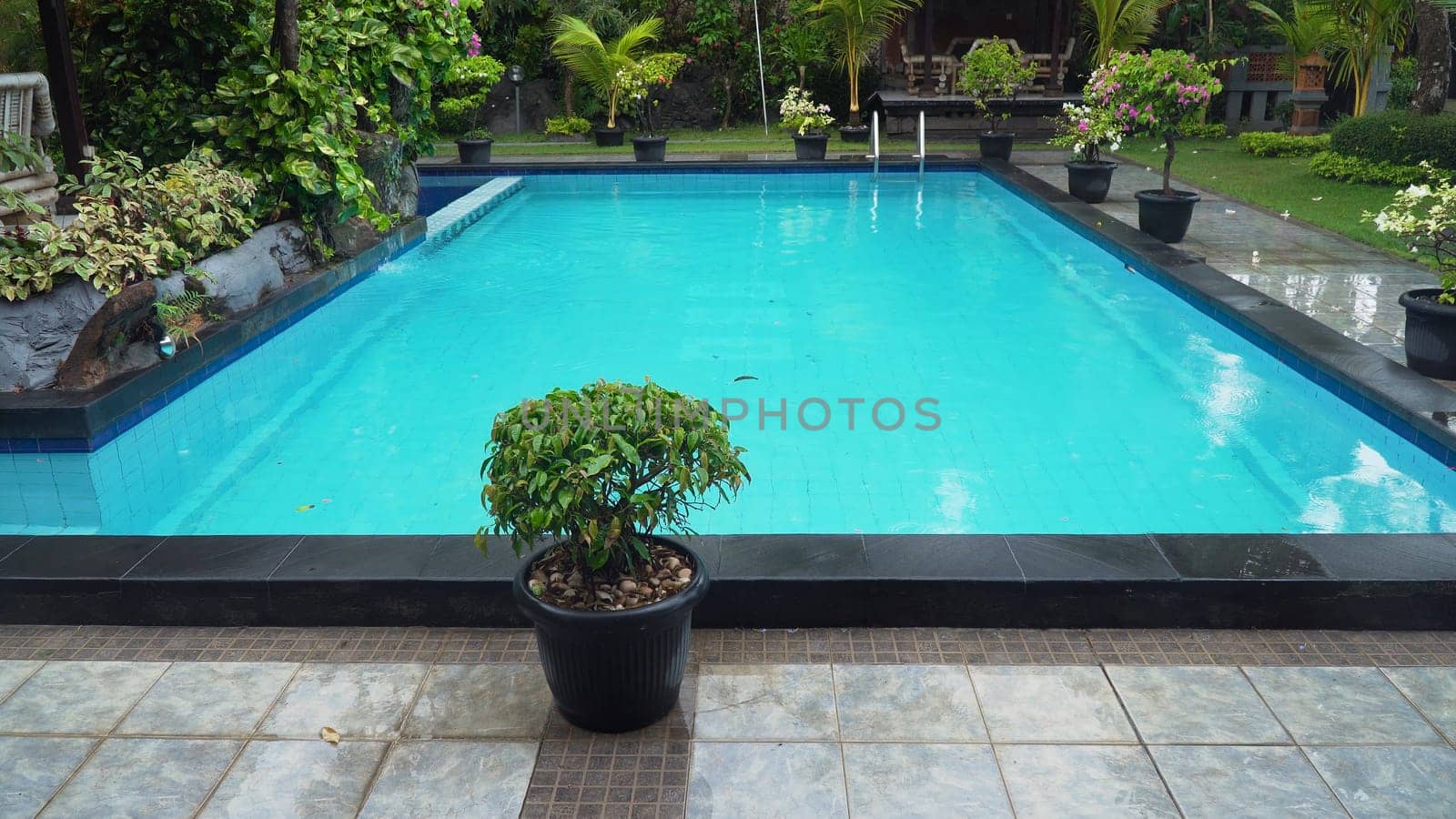 Luxurious open air swimming pool at resort. Swimming pool with turquoise water in a luxury hotel. Travel concept.