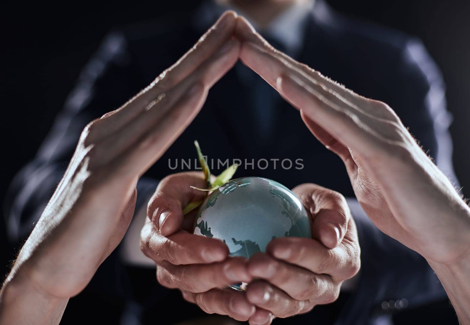 Businessman with the world in his hands on a black background