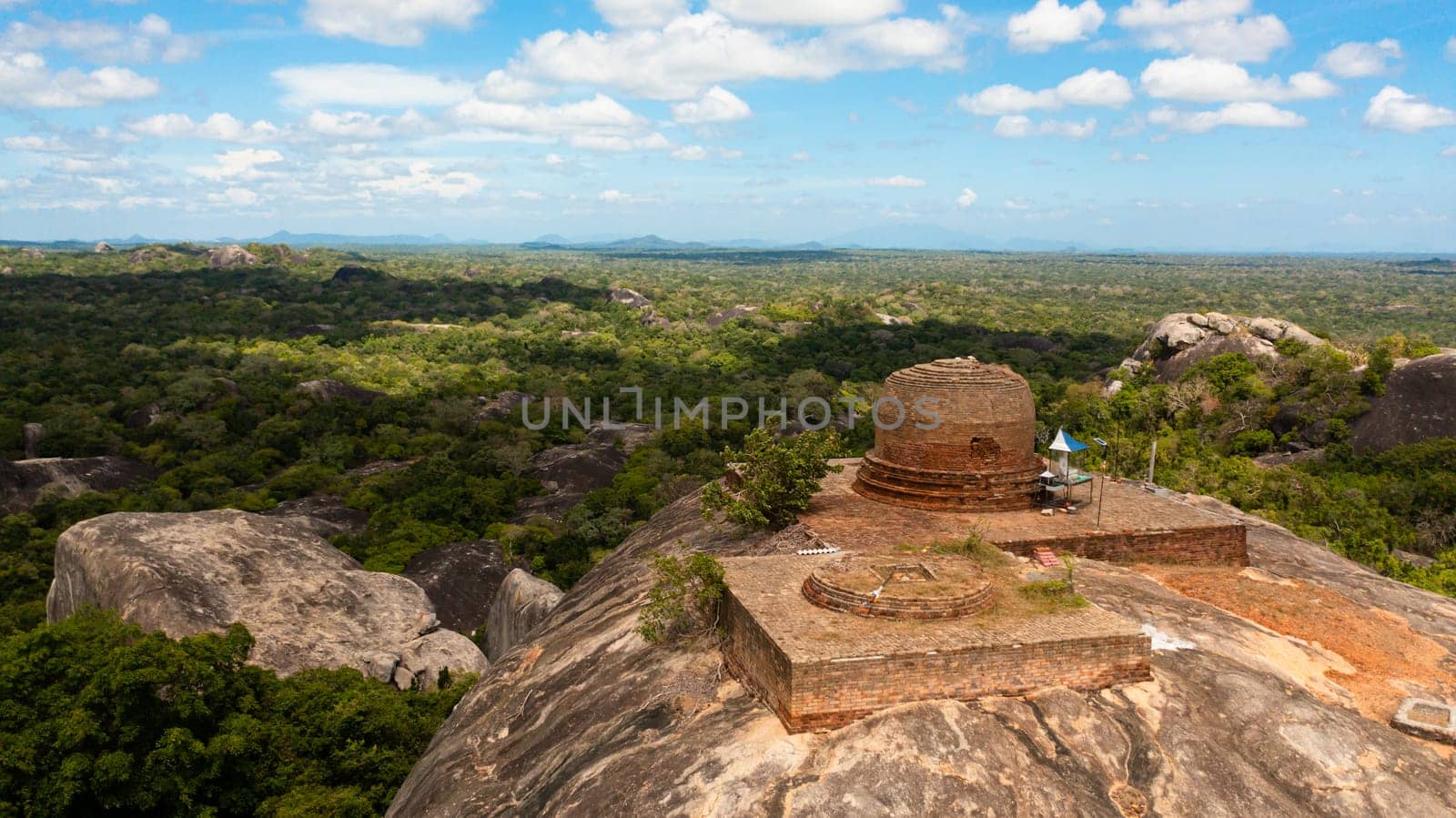 Kudumbigala Monastery Complex on rock and jungle against blue sky and clouds. Sri Lanka, Okanda.