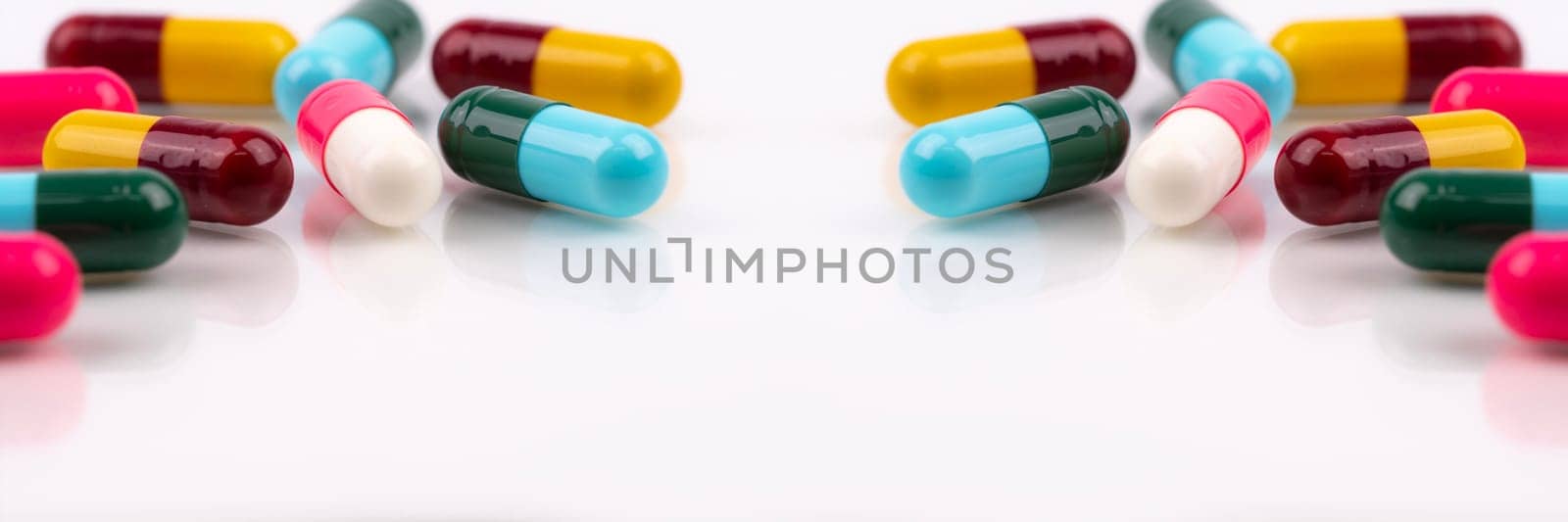 Antibiotic capsule pills on white background. Antibiotic drugs. Healthcare and medicine. Pharmaceutical industry. Prescription drugs. Pharmacology for pharmacists and doctors. Online pharmacy banner. by Fahroni