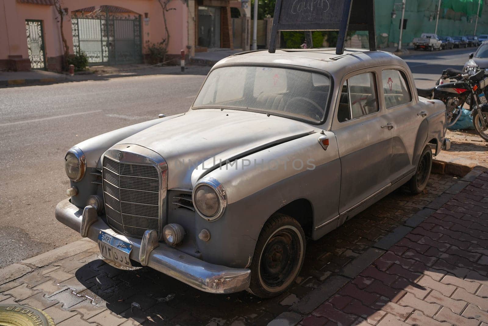 Old silver wedding car parking in the street. High quality photo