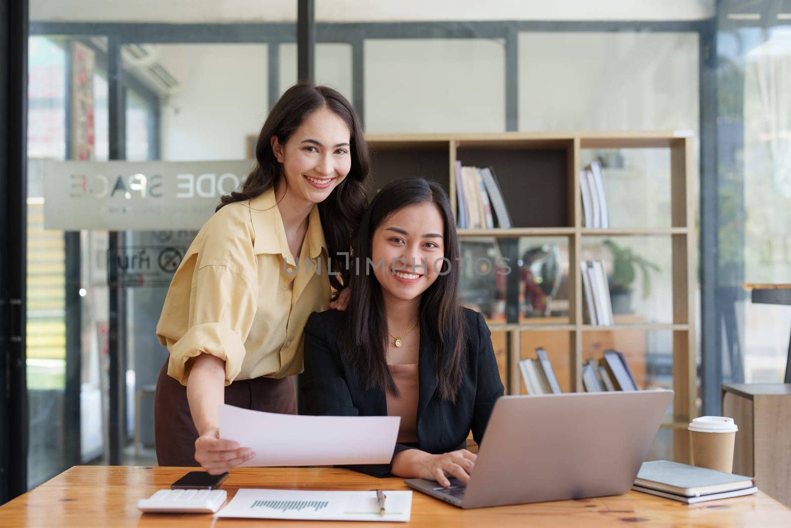 Asian Business team makes analysis and research financial report at office, analyzes profits. Accountant checks status of financial.