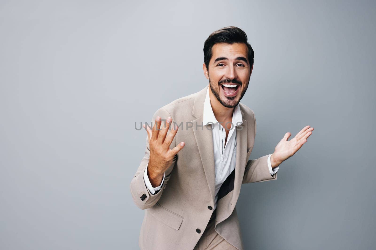 happy man arm beige posing businessman suit hand business winner victory by SHOTPRIME