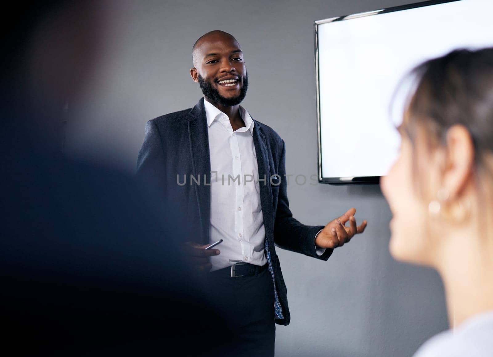 Meeting, presentation and training with a business black man in the boardroom for a coaching seminar. Management, education and planning with a young male speaker in he office during a workshop by YuriArcurs