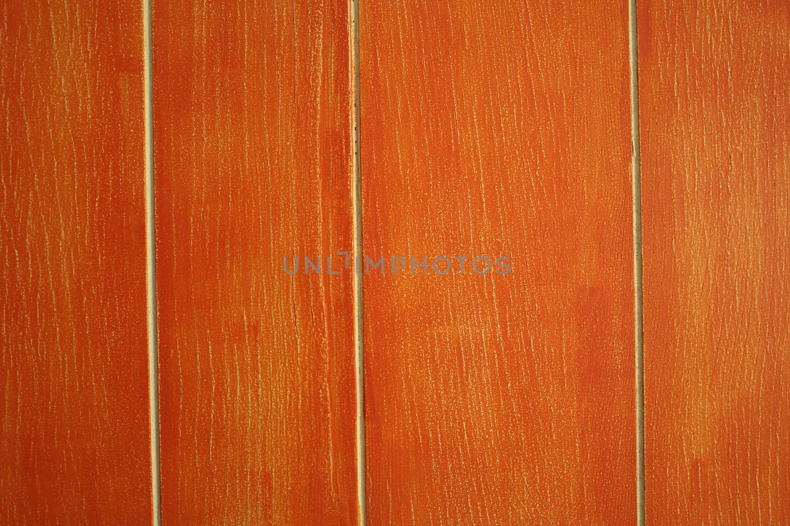 Orange wall made of wood like material. Meant as background