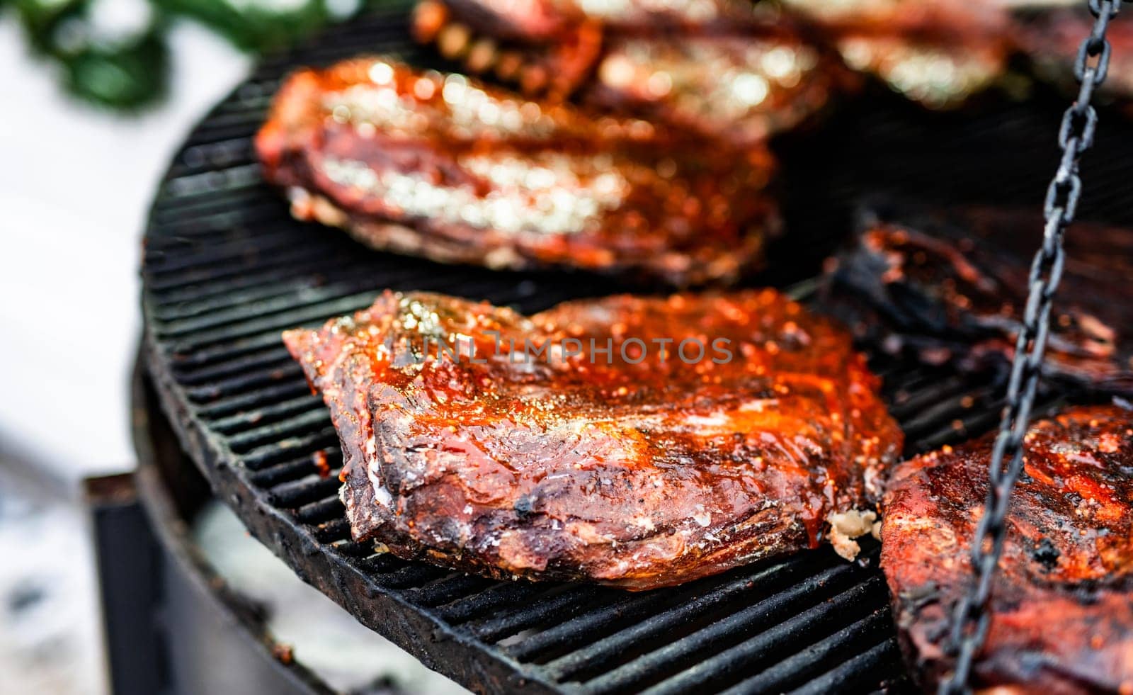 Barbecue grill meat at street food market. Fresh cooking delicious hot bbq beef on fire flame at traditional fair
