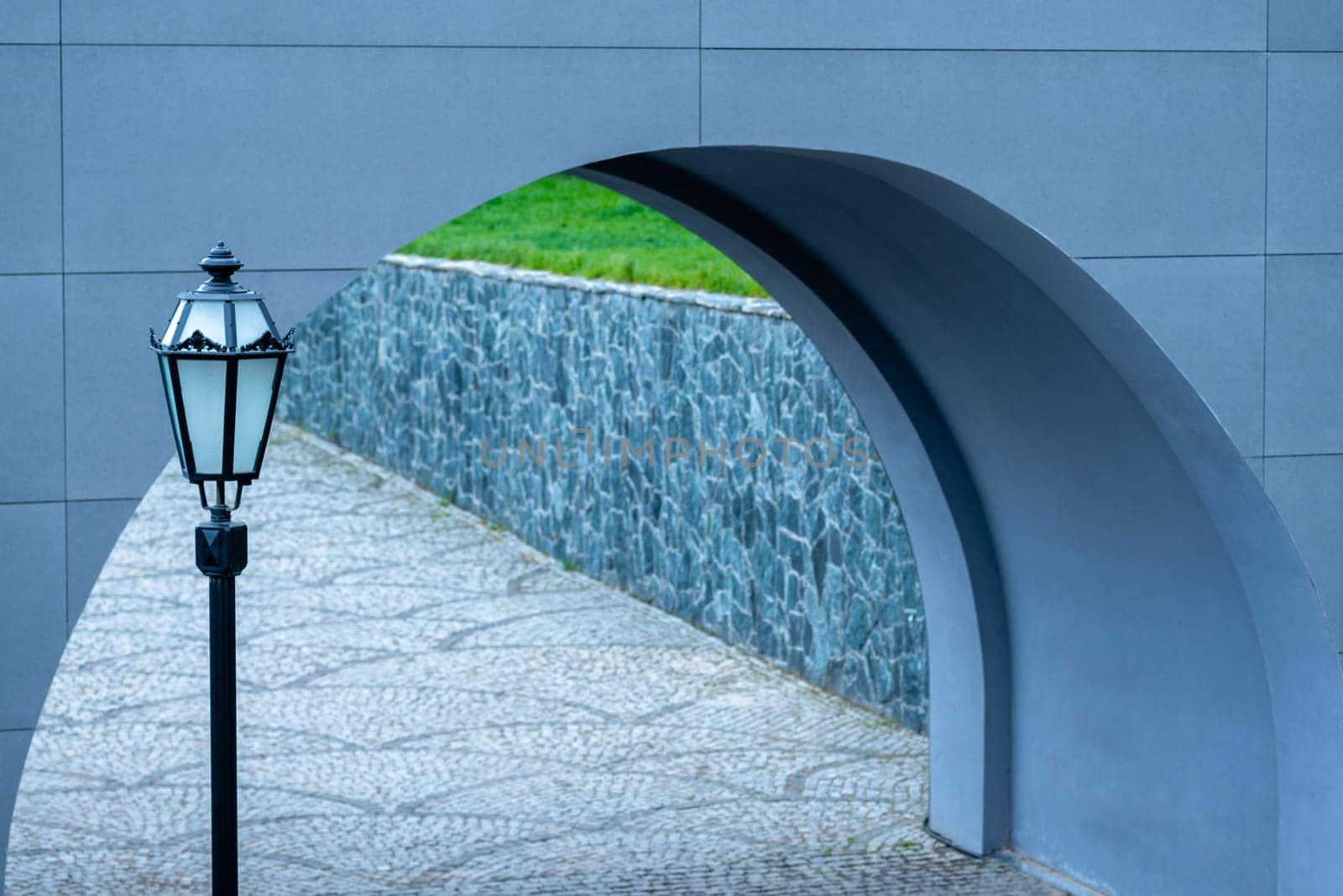 Street vintage lantern on the background of the arch of the bridge. by Renisons