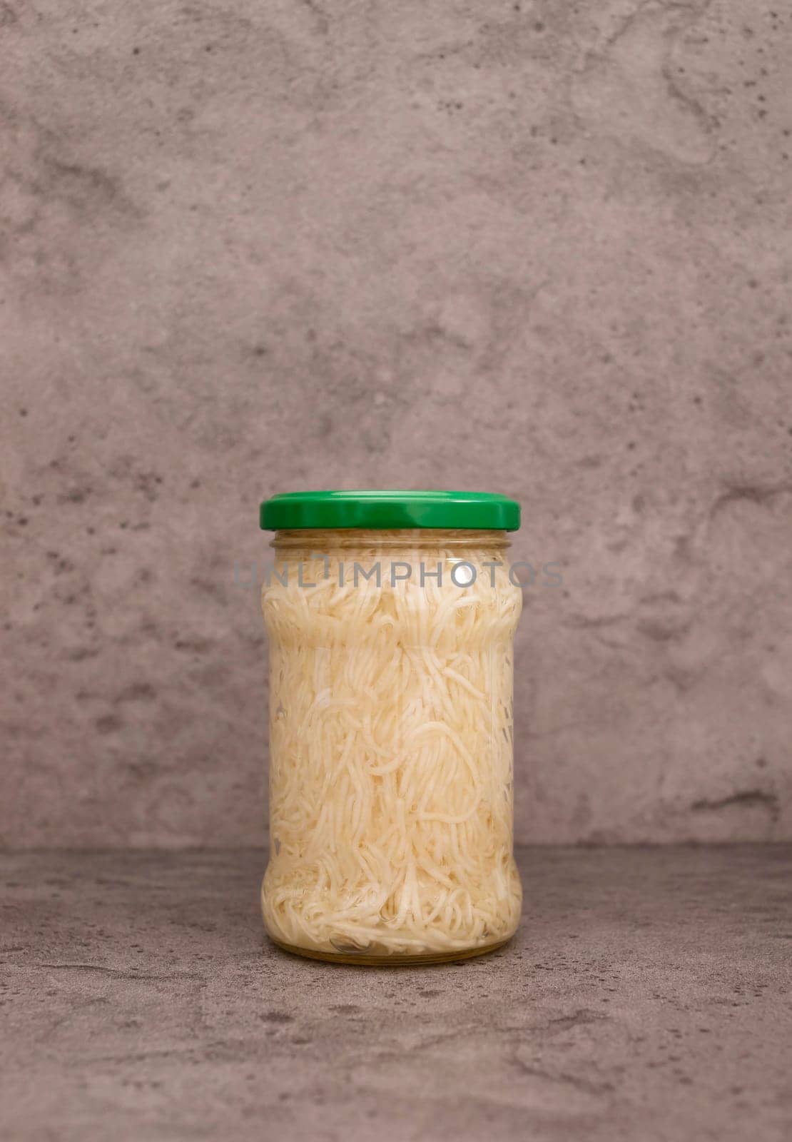 Celery Root Salad Preserve In Glass Jar With Screw Metal Cap On Shelf. Shredded And Pickled Celery Crops, Tuber. Apium Graveolens, Culinary. Vitamins C, K, A, E, PP, B. Copy Space, Vertical Plane.