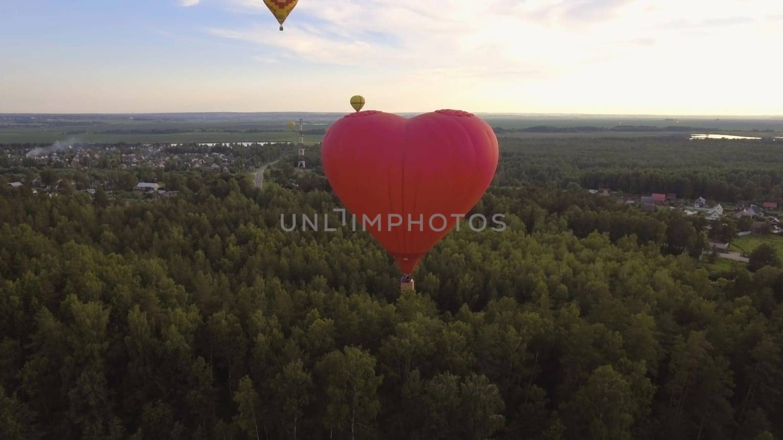 Hot air balloon shape of a heart in the blue sky. Aerostat, Airship. Red balloon.