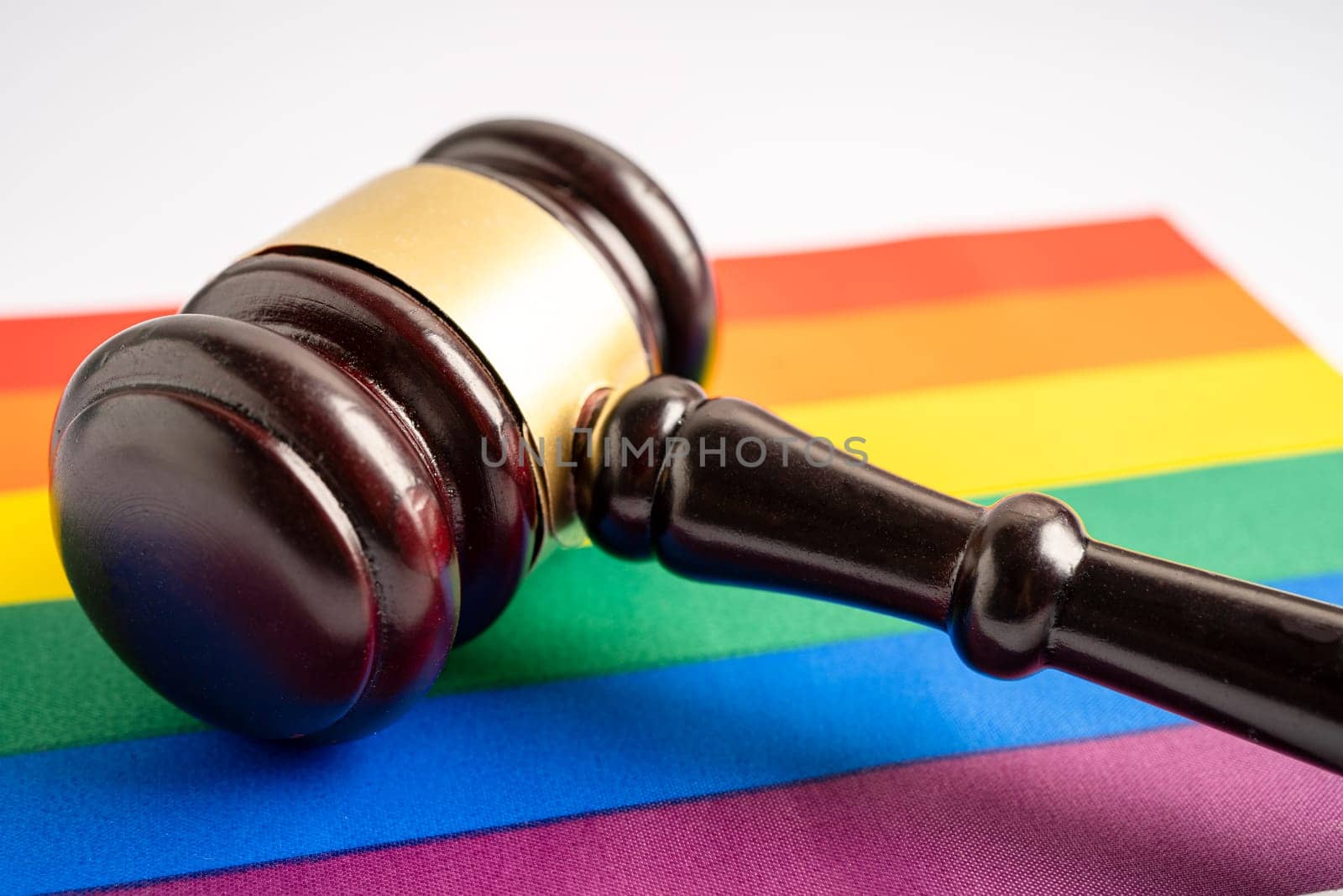 Gavel for judge lawyer on rainbow flag, symbol of LGBT pride month celebrate annual in June social of gay, lesbian, bisexual, transgender, human rights.