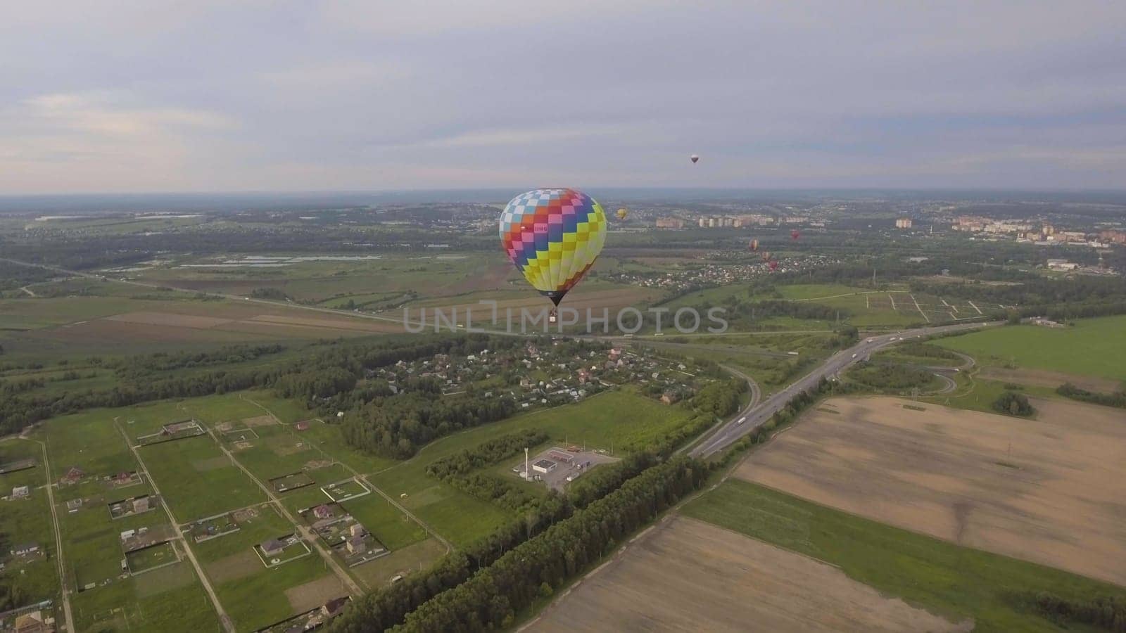 Hot air balloon in the sky over a field in the countryside. Aerostat fly in the countryside.