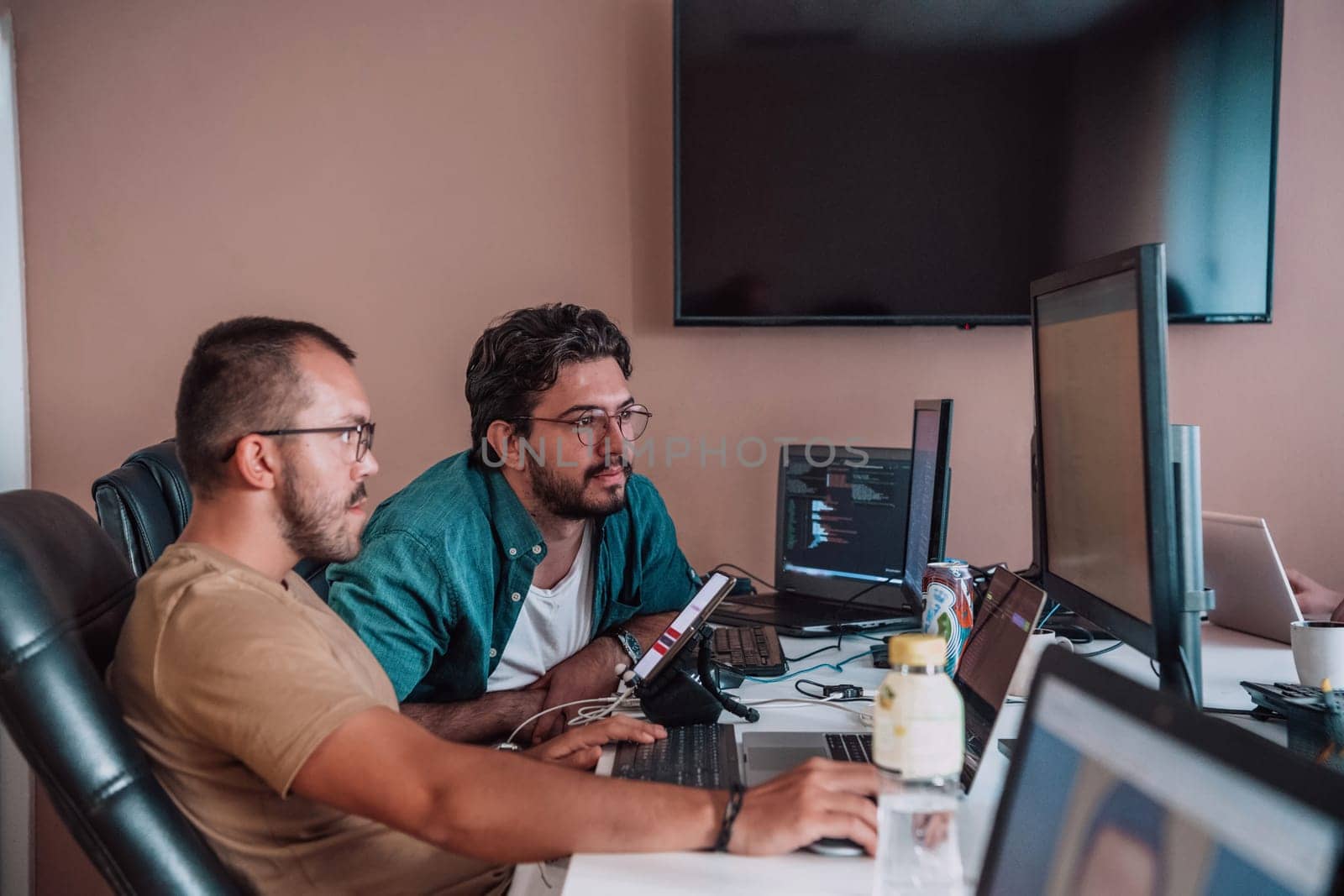 Programmers engrossed in deep collaboration, diligently working together to solve complex problems and develop innovative mobile applications with seamless functionality. by dotshock