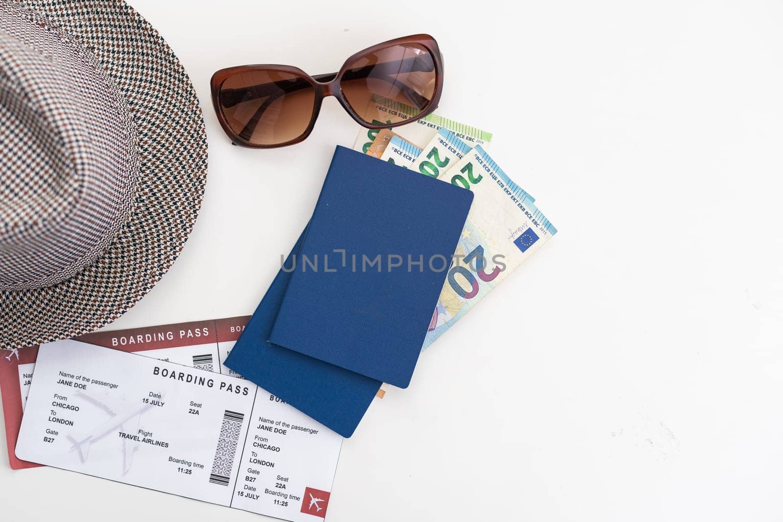 Top view of traveler accessories, hat, glasses, camera, passports and air tickets on background with copy space for text. Travel vacation concept.