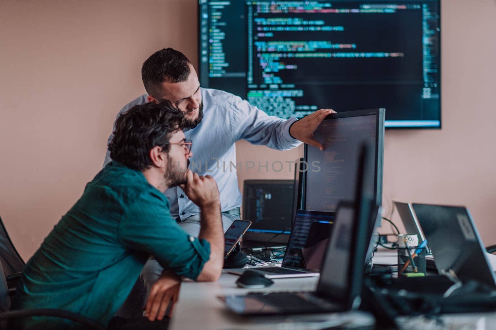 Programmers engrossed in deep collaboration, diligently working together to solve complex problems and develop innovative mobile applications with seamless functionality