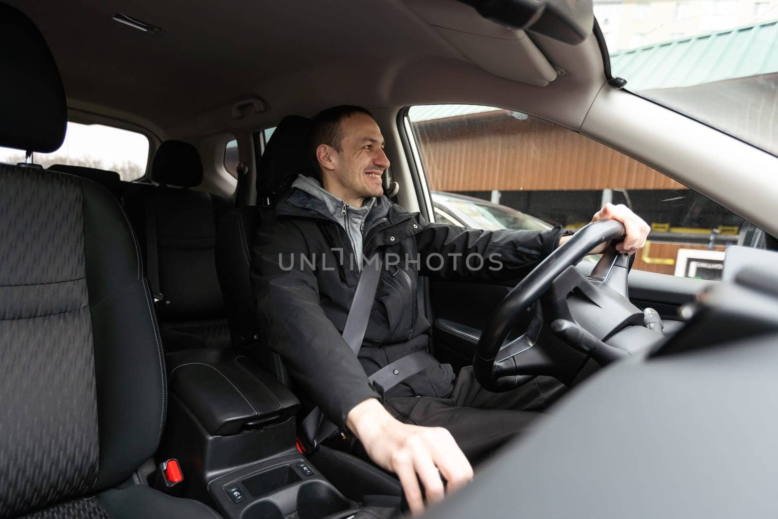 Attractive elegant happy man in good car by Andelov13