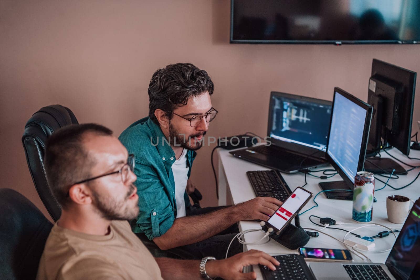 Programmers engrossed in deep collaboration, diligently working together to solve complex problems and develop innovative mobile applications with seamless functionality