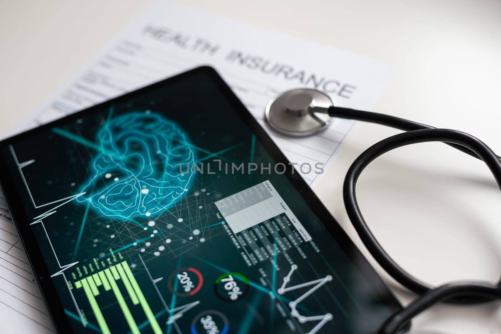 Paper with text Health insurance on the table with stethoscope.