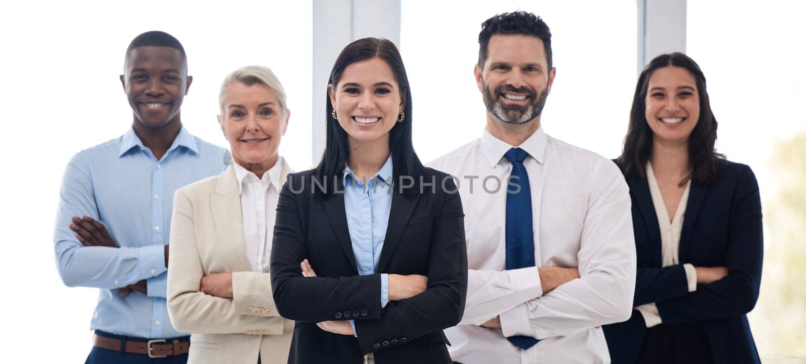Portrait, management and arms crossed with a business team standing together in their professional office. Collaboration, teamwork and leadership with a group of colleagues looking confident at work.