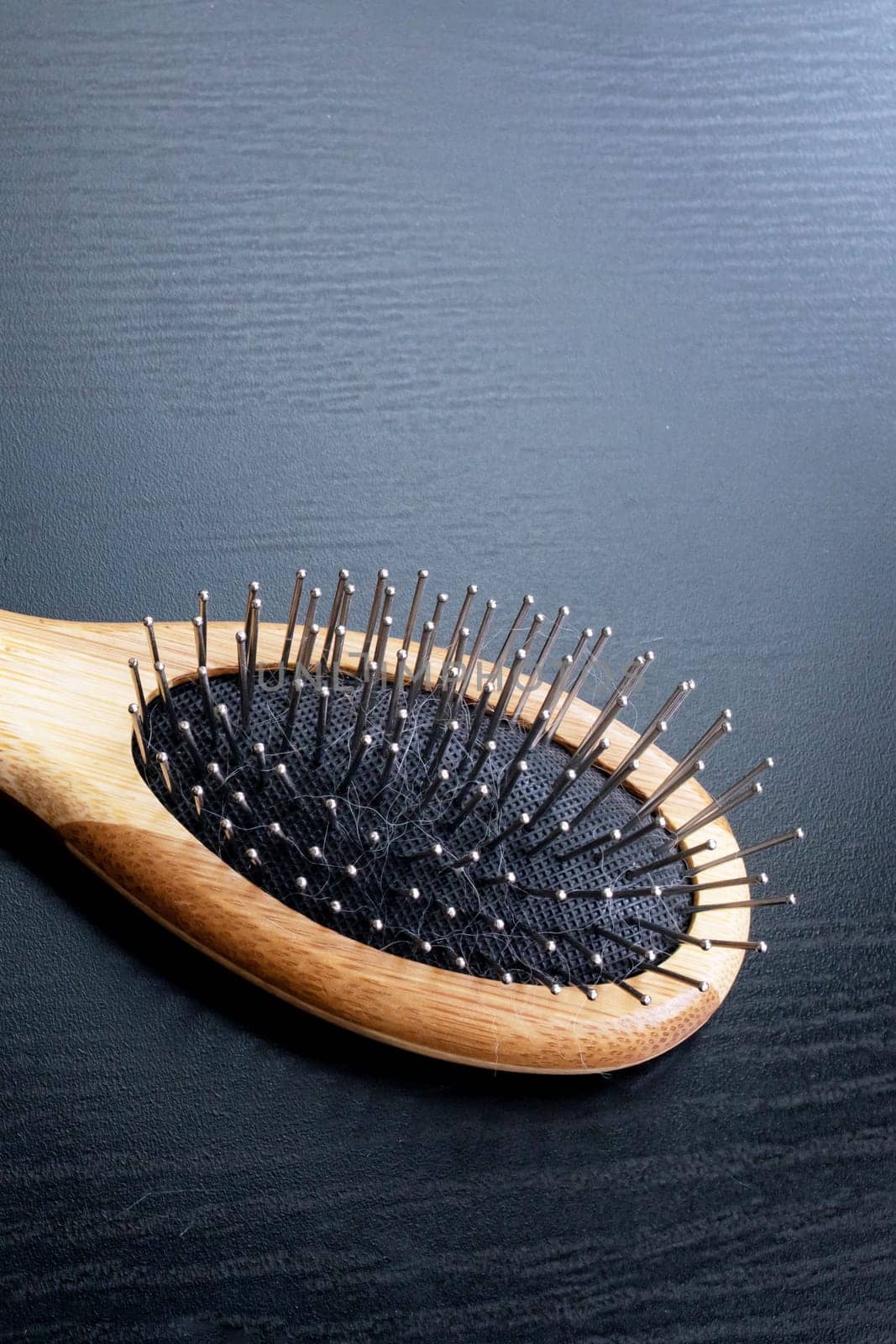 Wooden comb on a black background close up