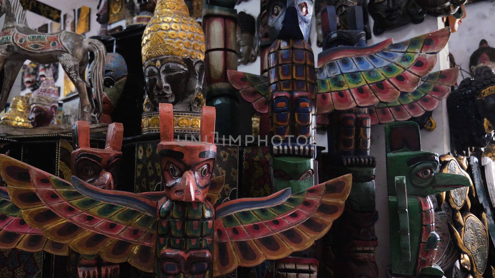 Hindu and Buddhist wooden carving. souvenir shop selling souvenirs and handicrafts of Bali at famous Ubud Market, Indonesia