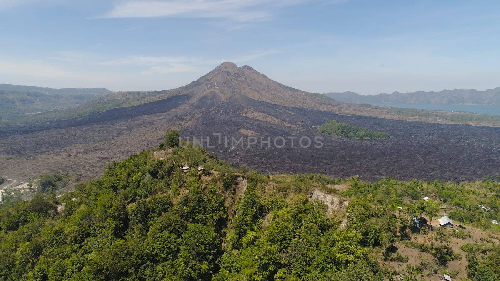 Aerial view volcano batur covered with vegetation mountain landscape with volcano sky and clouds Bali, Indonesia. Travel concept.