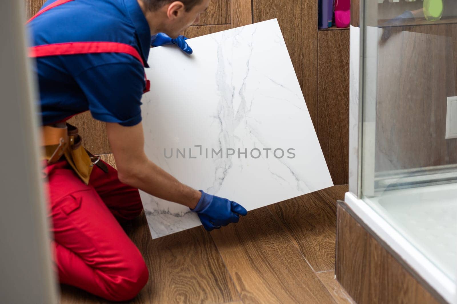 A nice handyman install tile on the floor. High quality photo