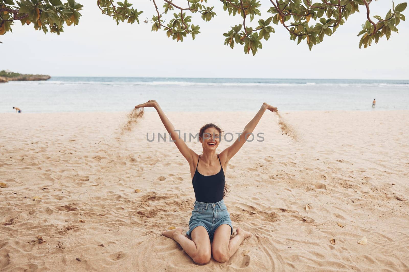 white woman travel sand sitting vacation beauty attractive caucasian tan holiday tropical freedom nature smile bali body person hair beach sea