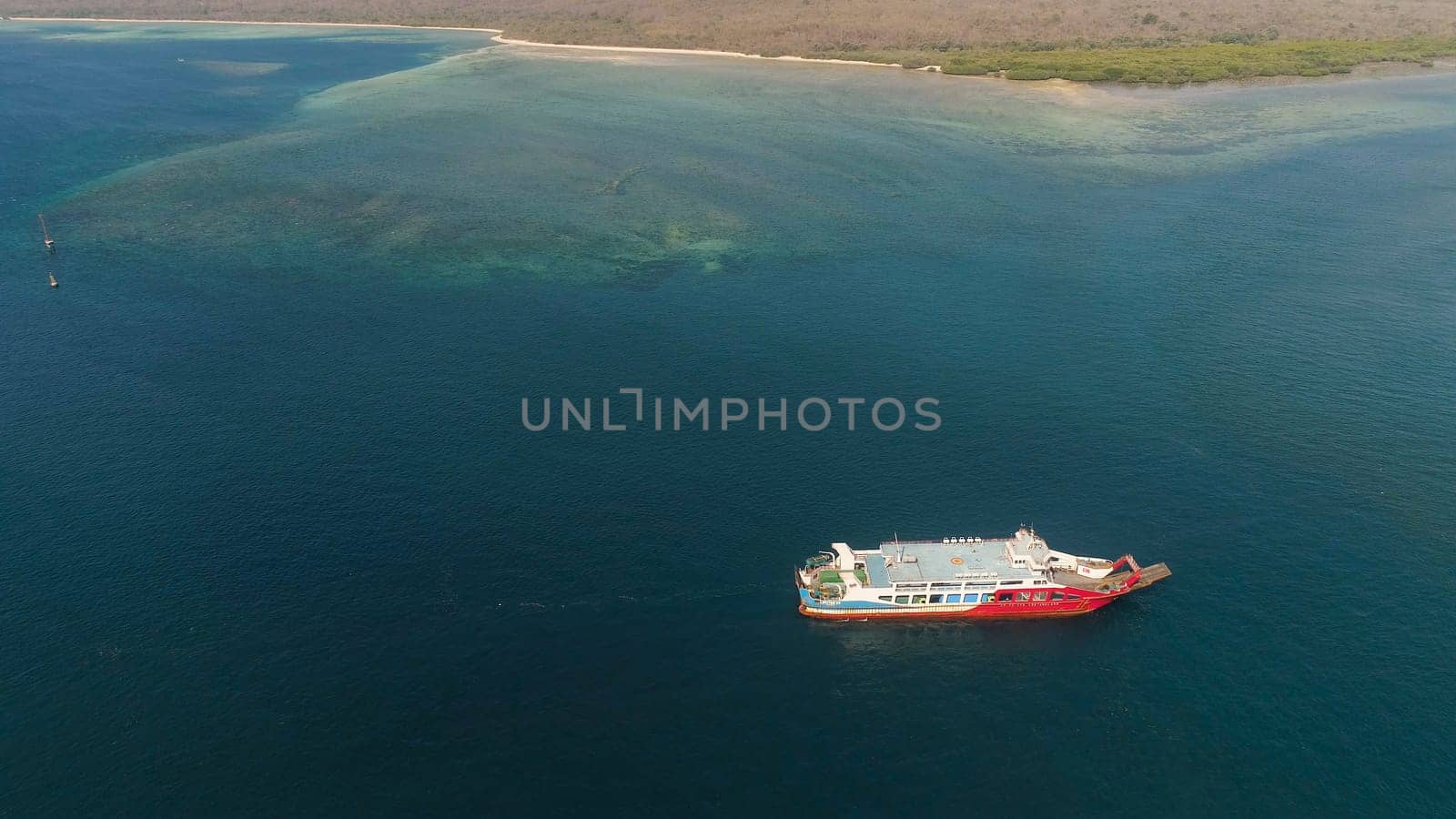 public ferry ships carrying passengers from Gilimanuk harbour ferry port in Bali Island to Ketapang harbour East Java, Indonesia