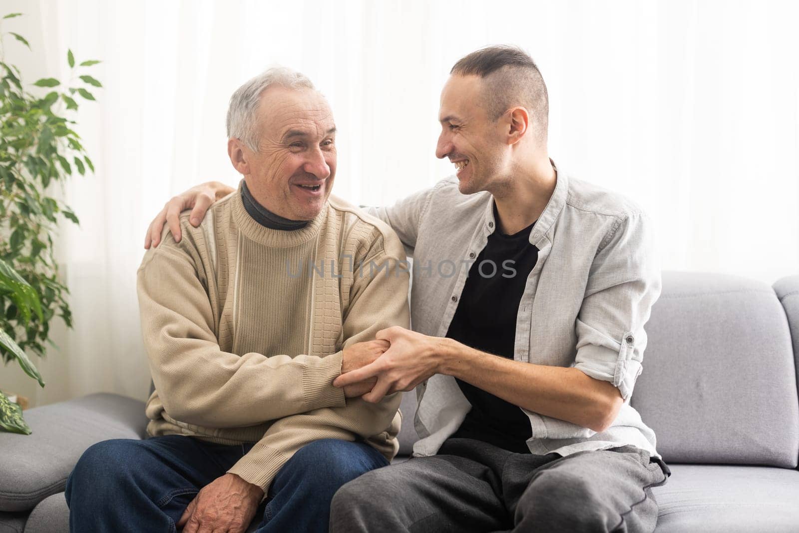 Help needed. Pleasant senior man sitting on the sofa by Andelov13