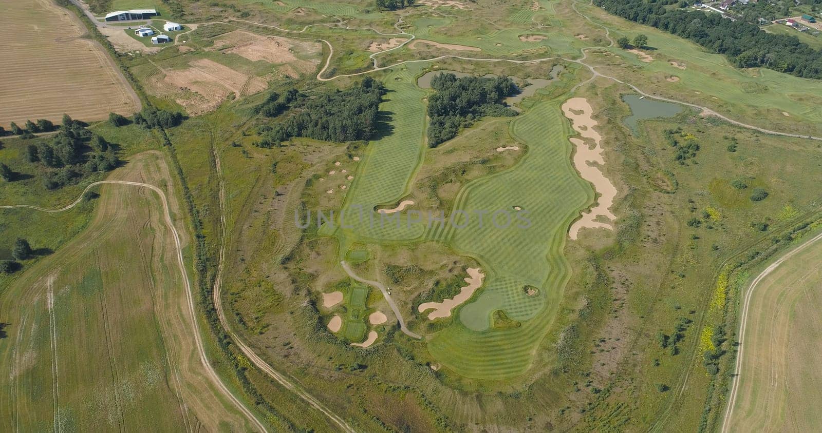 Aerial view Golf course with green grass and ponds. Golf field in the countryside.