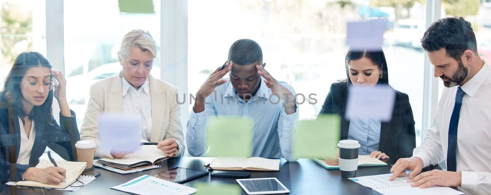 Meeting, planning and stress with a business team in a boardroom for strategy during a financial crisis. Finance, compliance or regulations with a group of colleagues in an office for problem solving.