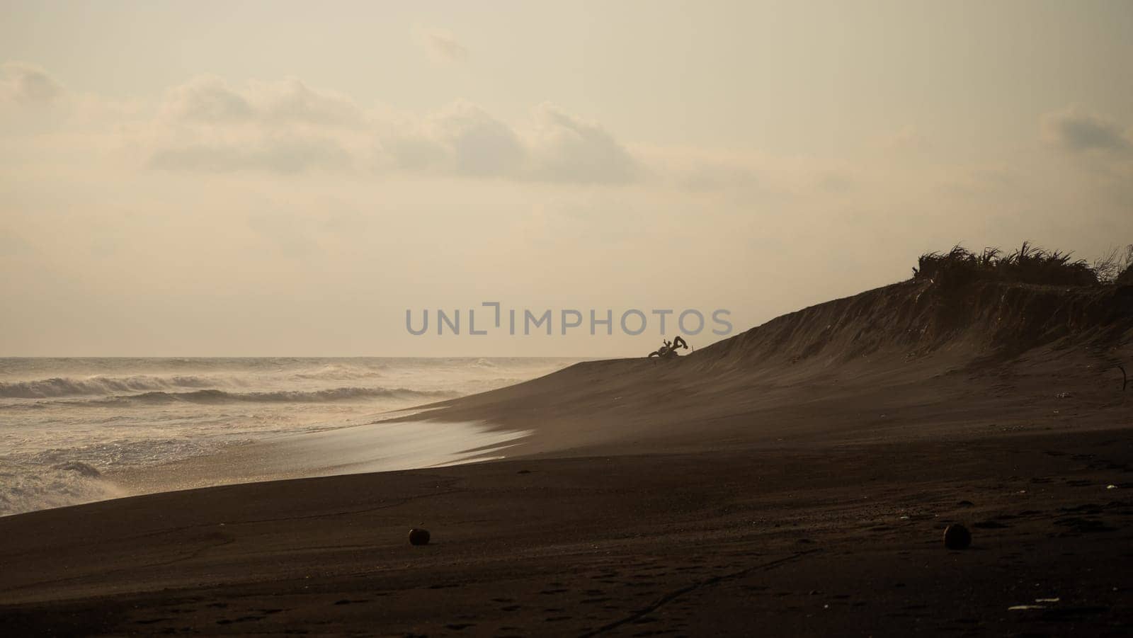 sandy beach near ocean with big waves at sunset time in tropical resort, Yogyakarta, Indonesia. seascape, ocean and beautiful beach. Travel concept. Indonesia, java