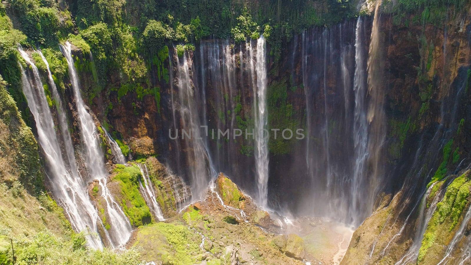 aerial view waterfall coban sewu in Java, indonesia. waterfall in tropical forest by drone Tumpak Sewu