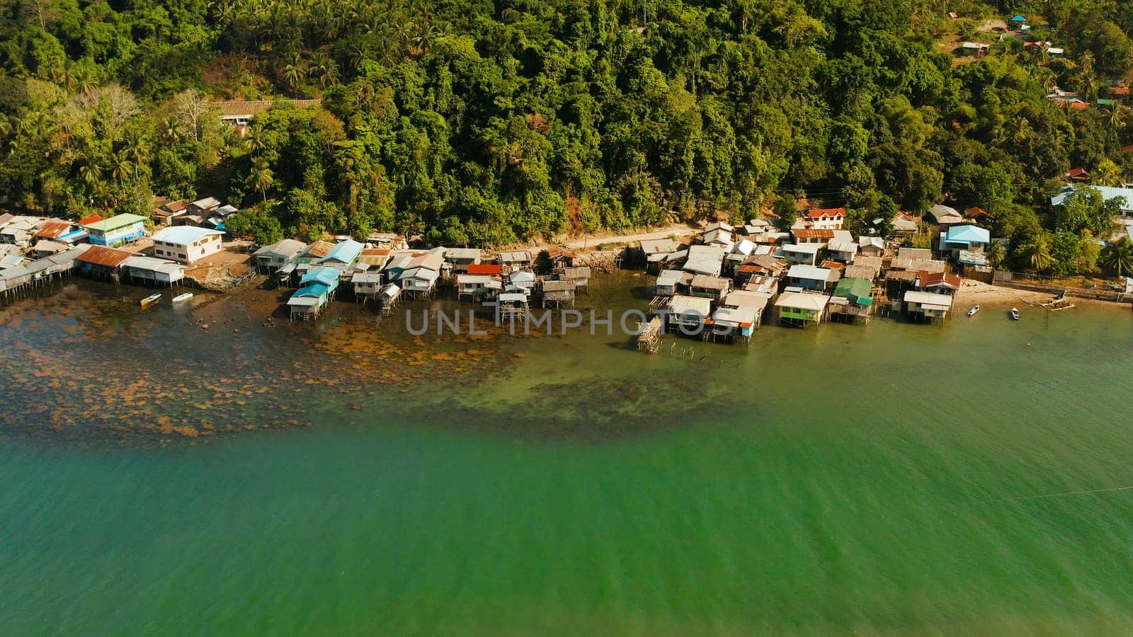 Village of stilt houses built over the sea, top view. City and port on Balabac Island, Palawan, Philippines.