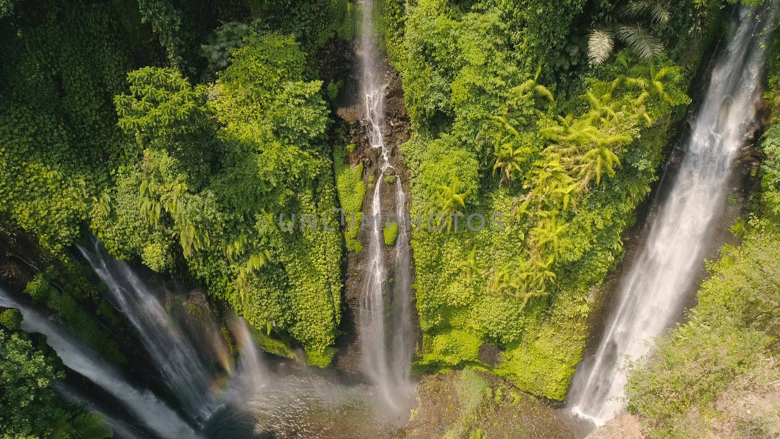 waterfall in green rainforest. Aerial view triple tropical waterfall Sekumpul in mountain jungle. Bali,Indonesia. Travel concept.