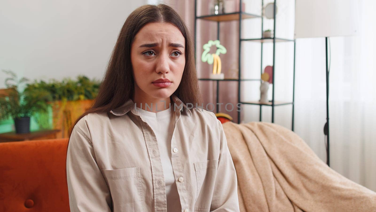 Upset disappointed young woman wipes tears and cries from despair, being sad because of unfair situation, unrequited love. Problem, break up, depressed feeling bad annoyed, burnout. Girl at home room