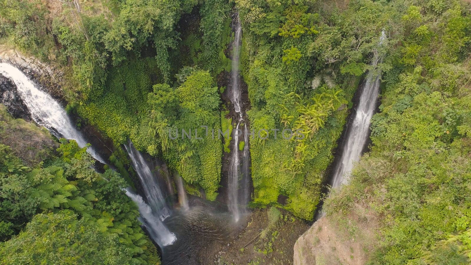 waterfall in green rainforest. Aerial view triple tropical waterfall Sekumpul in mountain jungle. Bali,Indonesia. Travel concept.