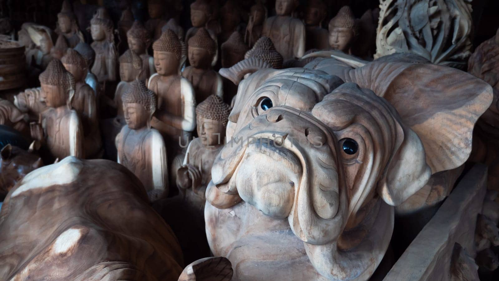 Hindu and Buddhist wooden carving. souvenir shop selling souvenirs and handicrafts of Bali at famous Ubud Market, Indonesia