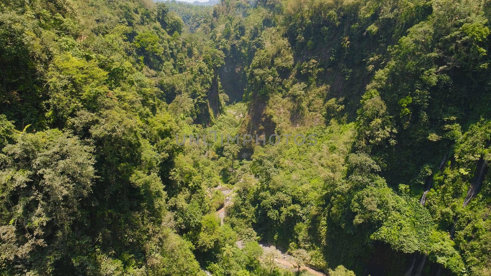 beautiful waterfall Coban Sewu in tropical forest, Java Indonesia. aerial view tumpak sewu waterfall in rainforest