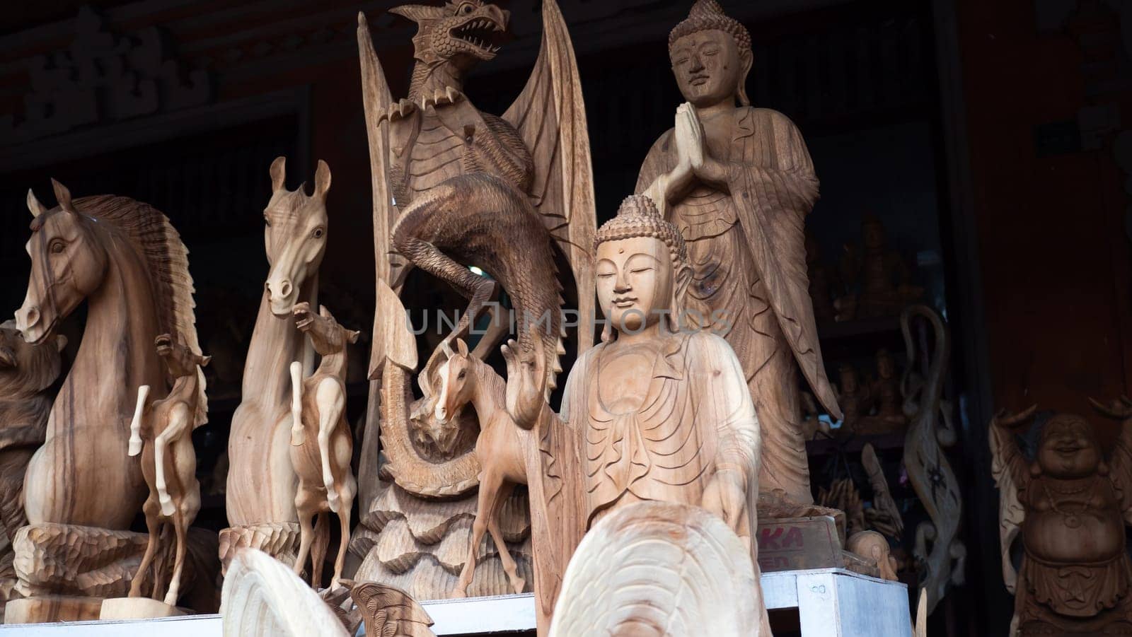 Hindu and Buddhist wooden carving. souvenir shop selling souvenirs and handicrafts of Bali at famous Ubud Market, Indonesia