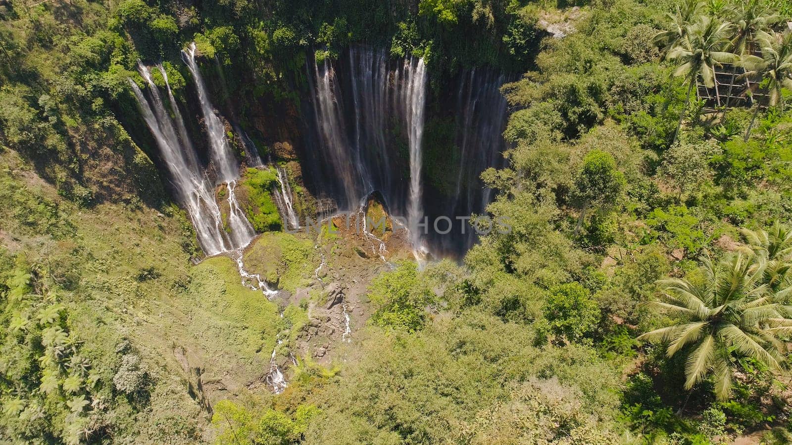 beautiful waterfall Coban Sewu in tropical forest, Java Indonesia. aerial view tumpak sewu waterfall in rainforest