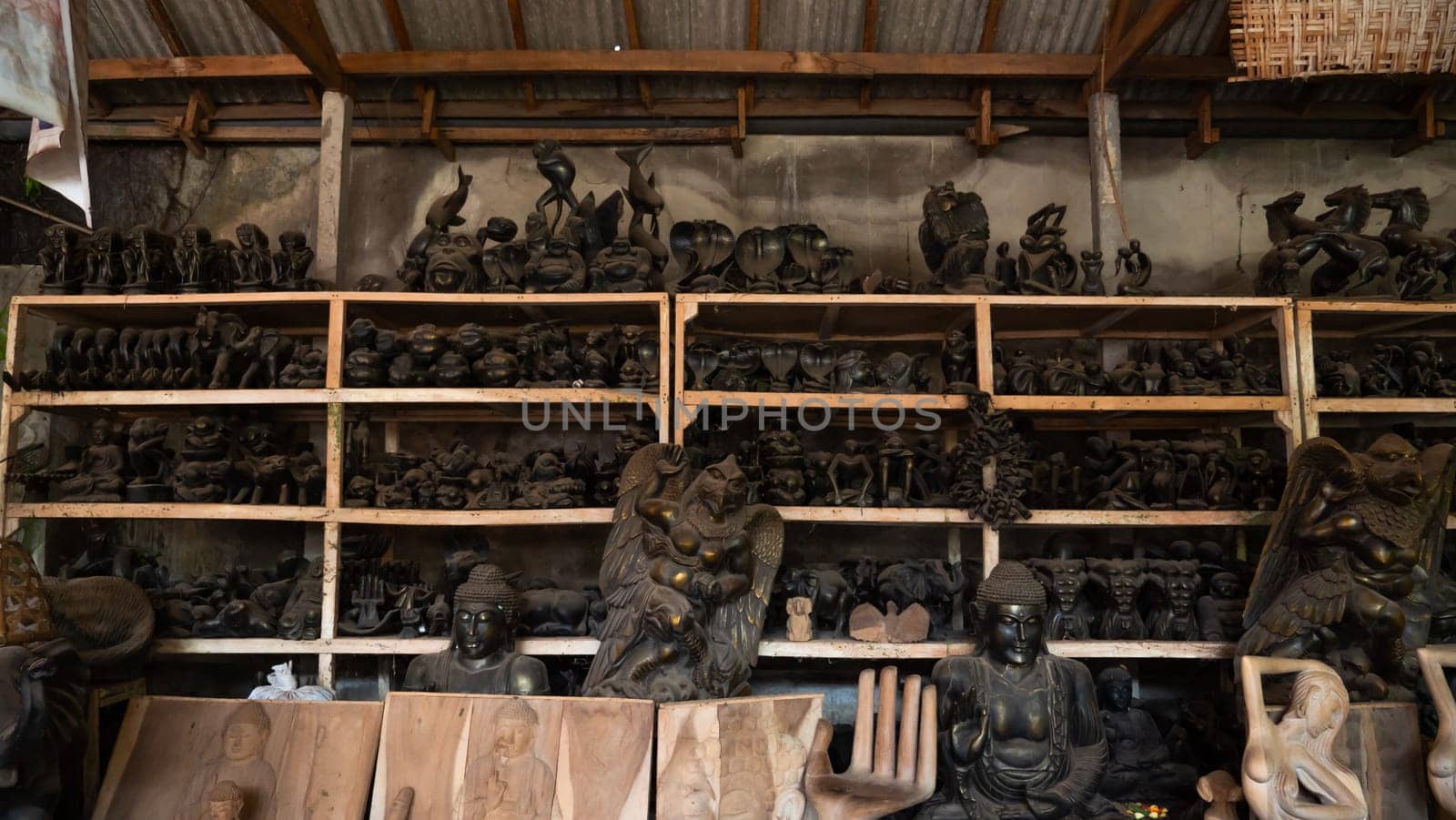 Hindu and Buddhist wooden carving. souvenir shop selling souvenirs and handicrafts of Bali at famous Ubud Market, Indonesia