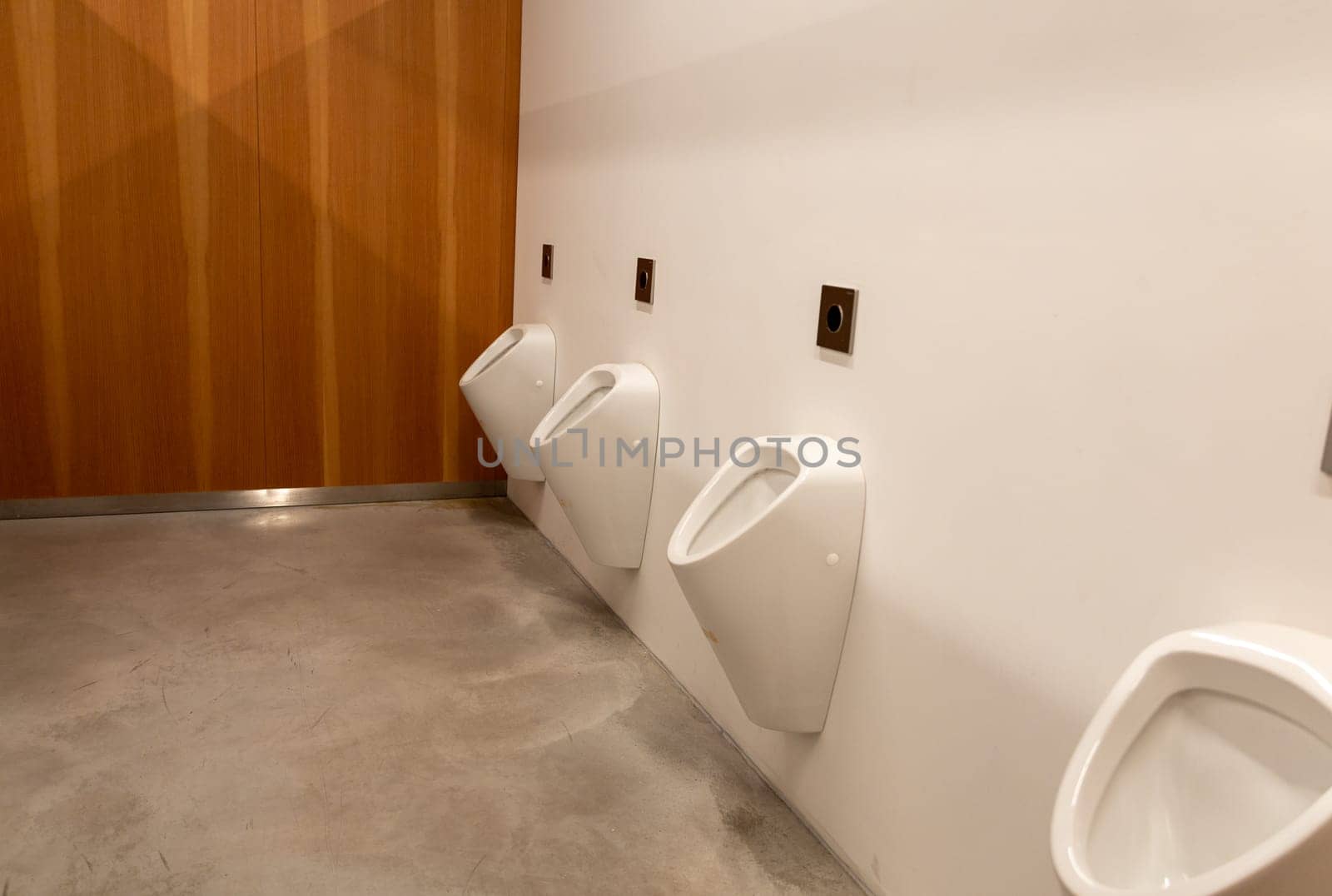 Public male toilet a line of urinals. High quality photo